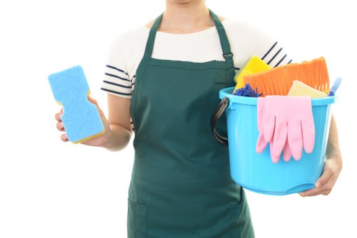Staff using safe carpet cleaning practices with warning signs and equipment