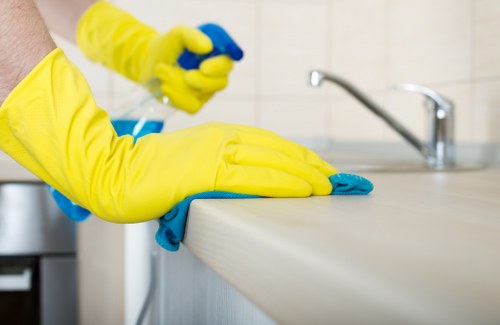 Cleaner wearing PPE while inspecting carpet cleaning area
